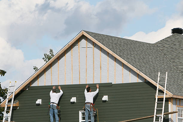 Professional Storm Damage Siding Repair technician working in Hudson, MA